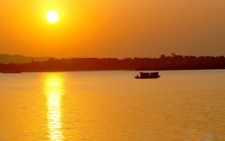 Boat sunset mountain ocean reflection - free ship wallpaper