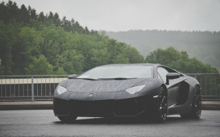 Black sports car parking lot 18 - a fence and trees free wallpaper