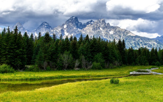 Grassy field stream mountains clouds - a grassy field free wallpaper