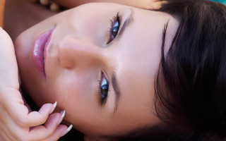 Blue eyed woman laying portrait - her cheek free wallpaper