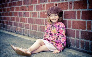 Little girl brick wall smiling 2 - a little girl free wallpaper