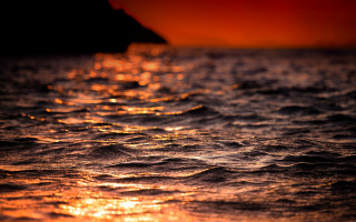 Sunset ocean waves boat red - a sunset over the ocean free wallpaper