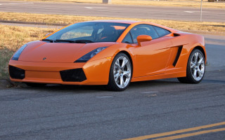 Bright orange sports car roadside - the side of the road in front free wallpaper