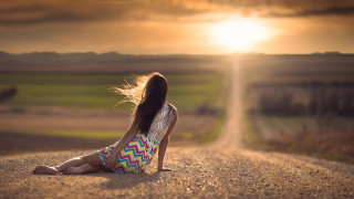 Woman sitting sunset beach blurry - the side of a road free wallpaper
