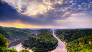 River valley clouds sunshine landscape - a lush green valley under a cloudy sky free wallpaper