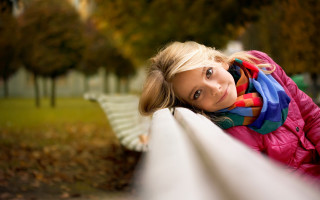 Woman park leaning white rail - the background and a bench in the foreground free wallpaper