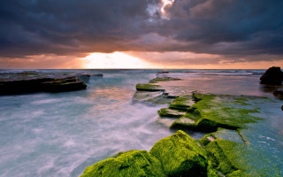 Sunset ocean rocks water mountains - rich moody colour free wallpaper