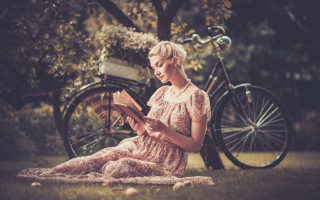 Woman sitting grass reading bicycle - a basket free wallpaper
