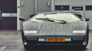Black sports car garage open - the front of it free wallpaper