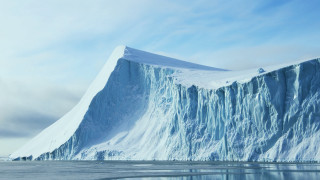 Large iceberg mountain water sky - ice free wallpaper
