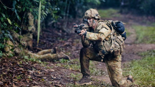 Camouflage man crouching camera forest - a path free wallpaper