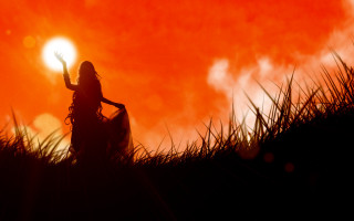 Woman sunset field fire embers - a red sky in the background free wallpaper