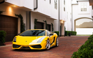 Yellow sports car building driveway - vibrant color free wallpaper