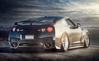Black sports car cloudy sky 2 - a road under a cloudy sky free wallpaper