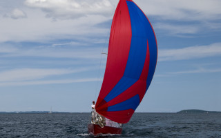Red blue sailboat ocean cloudy - a sailboat in the background free wallpaper