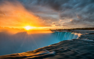 Waterfall sunset clouds lake mountain - a large waterfall free wallpaper