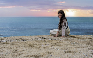Beach sunset woman waterboat sand - a sunset in the background and a body of water free wallpaper