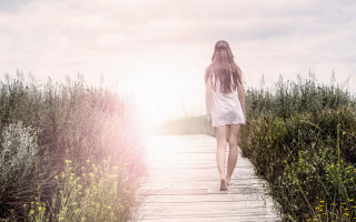 Woman walking flower field sunset - the sun free wallpaper