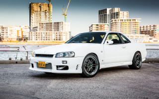 White car city skyline crane - a parking lot next free wallpaper
