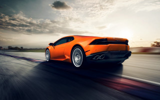 Bright orange sports car sunset 2 - dramatic free wallpaper
