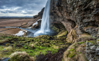 Waterfall river mountains grassy horizon - a cliff in the distance free wallpaper