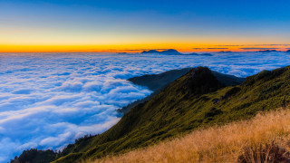 Mountain grassy slope sunset colorful - a sunset in the distance free wallpaper