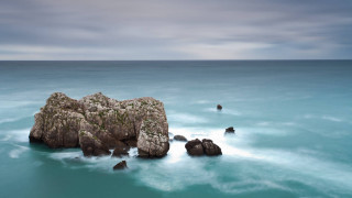 Rock formation ocean clouds sky 2 - a body of water below free wallpaper