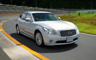 White car driving green hillside - a road next free wallpaper