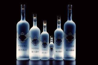 Vodka bottles table black background - a group of bottles free wallpaper