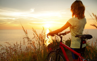 Woman bike ocean sunset scenery - the sun setting free wallpaper