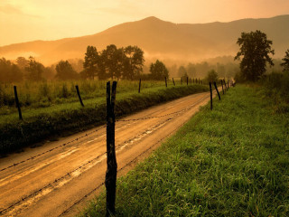 Dirt road fence field sunset 3 - a fence and a field in the background free wallpaper