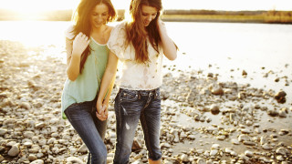 Beach two women holding hands - a rocky beach next free wallpaper
