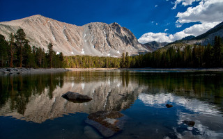 Mountain lake rock trees water - a rock in the middle of it free wallpaper