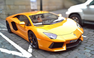 Yellow toy car cobblestone street - a white car free wallpaper