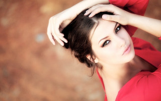 Woman red top hands head - a bun free wallpaper