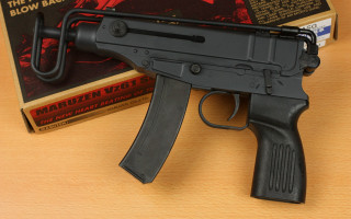 Toy gun book table foreground - viennese actionism free wallpaper