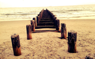 Wooden posts beach waves sunset - wave free wallpaper