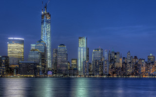 City skyline night water lit 2 - a large body of water in front free wallpaper