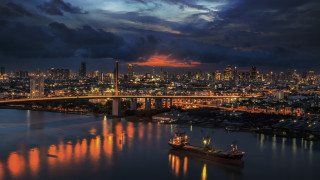 Docked boat bridge city night - orange glow free wallpaper