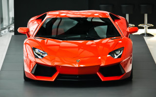 Bright orange sports car showroom - a showroom free wallpaper