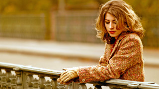 Woman leaning rail blonde blurry - a jacket free wallpaper
