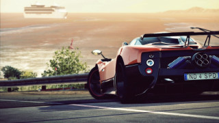 Luxury car ocean road beach - a boat in the background free wallpaper