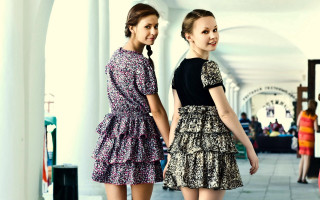 Two women hallway smiling dresses - floral free wallpaper