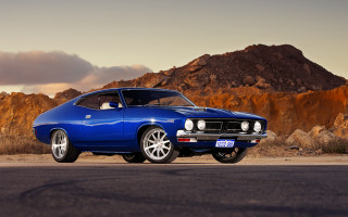 Blue muscle car mountain sunset 2 - a cloudy sky in the background free wallpaper