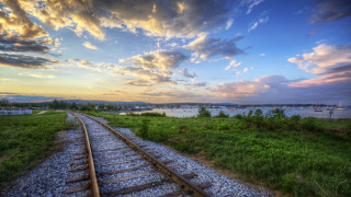 Sunset traintrack water boat city - a boat in the distance free wallpaper