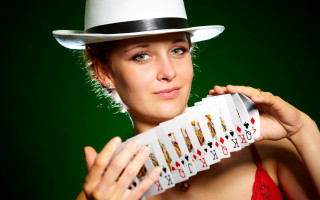 Woman white hat cards green - a green background behind her free wallpaper