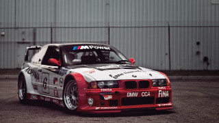 Bmw racecar parkinglot building sign 2 - the side of the car free wallpaper