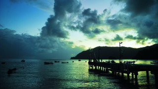 Pier boats cloudy sunset mountain - a mountain in the distance free wallpaper