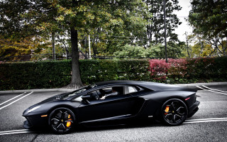 Black sports car parking lot 38 - a person in the driver seat free wallpaper