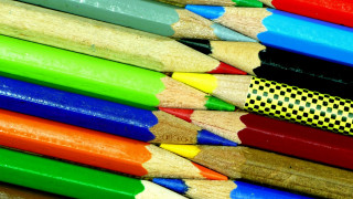 Colored pencils closeup black background - a childs drawing free wallpaper